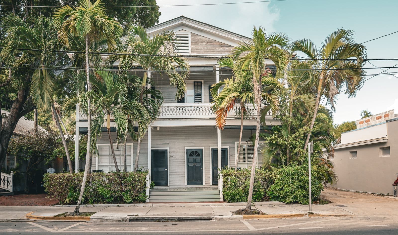 Sunny Southern California home exterior with palm trees, ready for summer cleanout